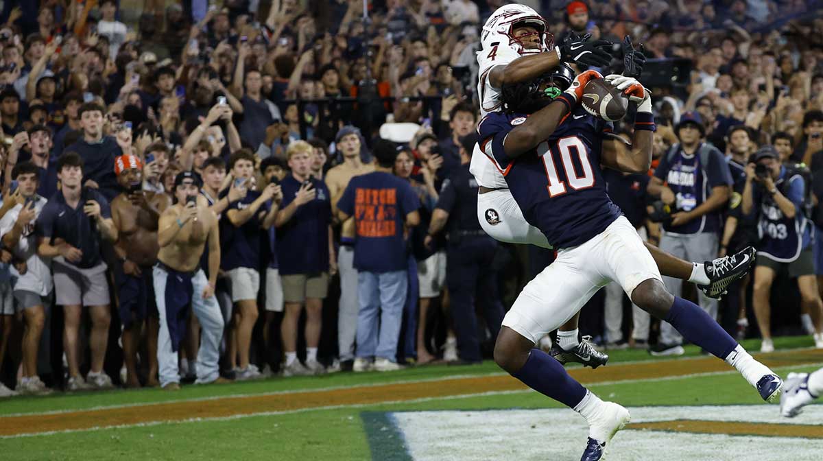 Virginia Cavaliers defensive back Ja'son Prevard (10) makes a game winning interception in the end zone on a pass intended for Florida State Seminoles wide receiver Squirrel White (4) in the second overtime period at Scott Stadium.