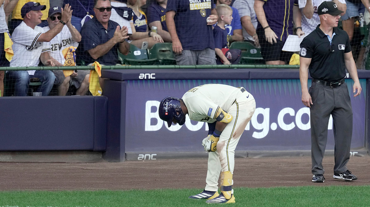 Milwaukee Brewers center fielder Jackson Chourio (11) bends over after a possible injury after hitting a single during the second inning of their National League Division Series game against the Chicago Cubs