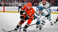 Anaheim Ducks defenseman Jackson LaCombe (2) moves the puck against San Jose Sharks center Cam Lund (46) during the second period at Honda Center.