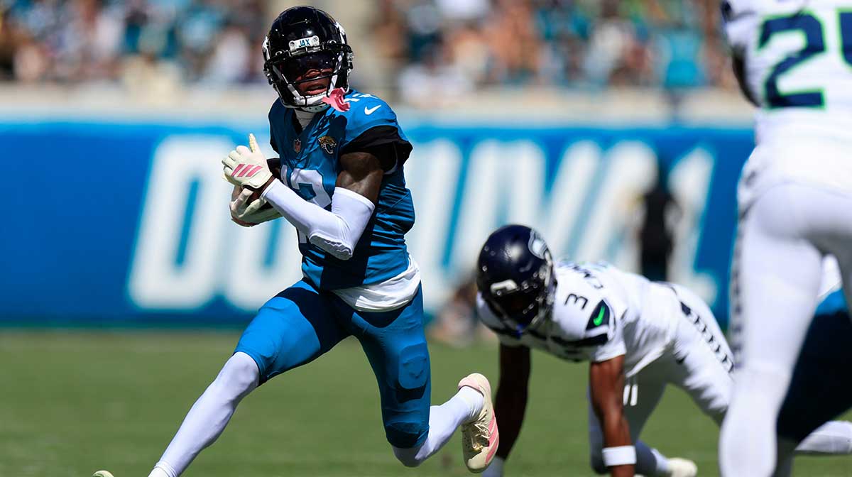Jacksonville Jaguars wide receiver Travis Hunter (12) rushes for yards against Seattle Seahawks
