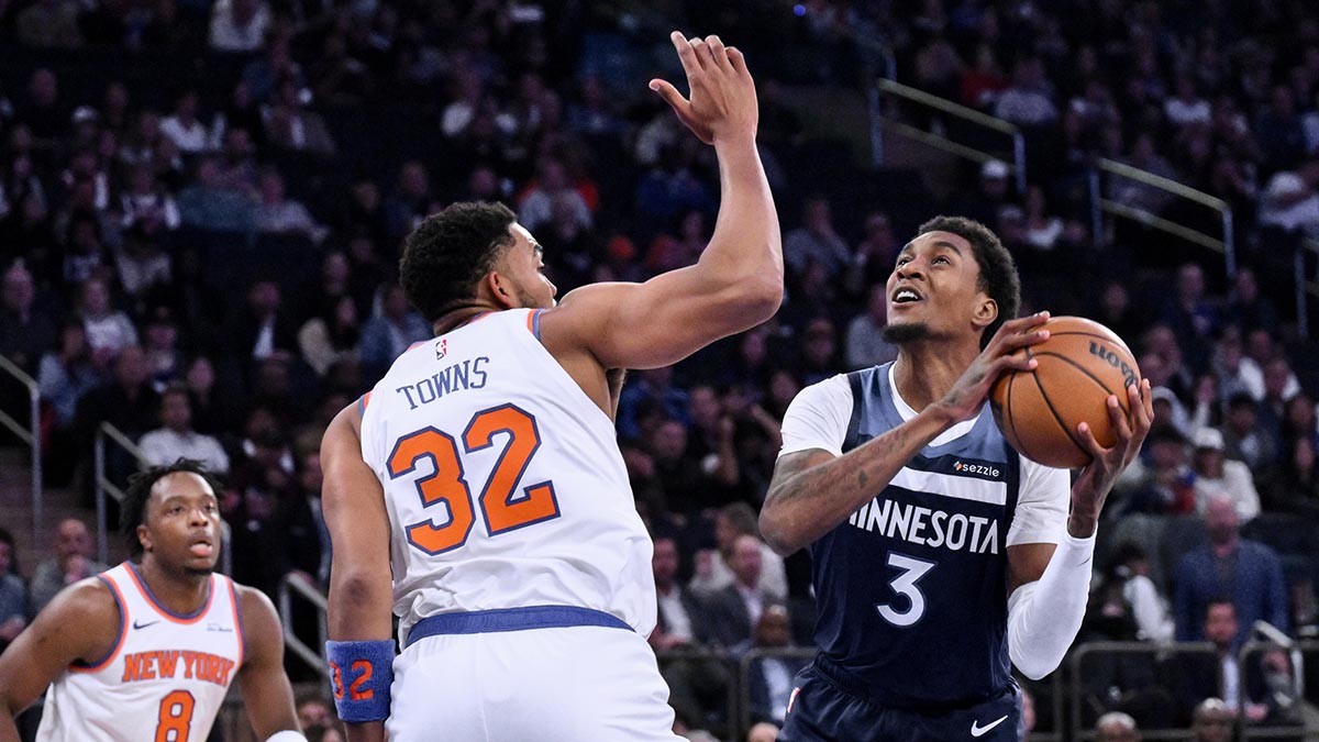 Minnesota Timberwolves forward Jaden McDaniels (3) shoots the ball while defended by New York Knicks center/forward Karl-Anthony Towns (32) during the first half at Madison Square Garden.