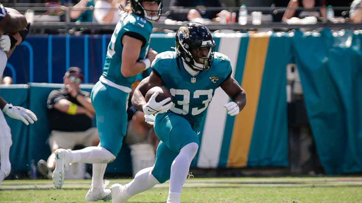 Jacksonville Jaguars running back Bhayshul Tuten (33) runs the ball against the Seattle Seahawks at EverBank Stadium.