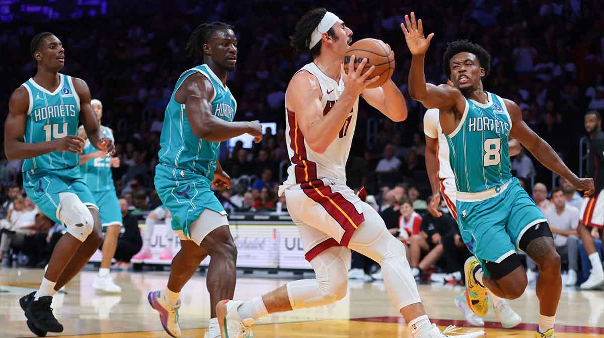 Miami Heat guard Jaime Jaquez Jr. (11) drives to the basket against Charlotte Hornets guard Collin Sexton (8) during the fourth quarter at Kaseya Center.