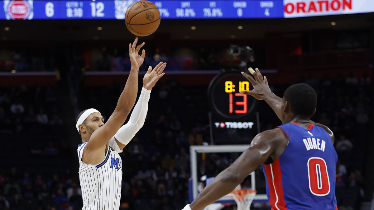 Orlando Magic guard Jalen Suggs (4) shoots on Detroit Pistons center Jalen Duren (0) in the first half at Little Caesars Arena.