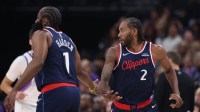 Los Angeles Clippers forward Kawhi Leonard (2) slaps hands with guard James Harden (1) after a basket against the Utah Jazz during the first quarter at Delta Center.