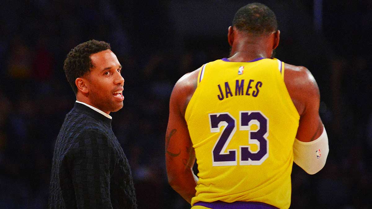 Los Angeles Lakers forward LeBron James (23) speaks with businessman Maverick Carter (left) during a stoppage in play in the second half at Staples Center.