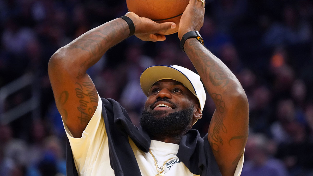 Los Angeles Lakers forward LeBron James (23), wearing a Los Angeles Dodgers hat, watches from the sideline during a break against the Golden State Warriors in the third quarter at Chase Center.