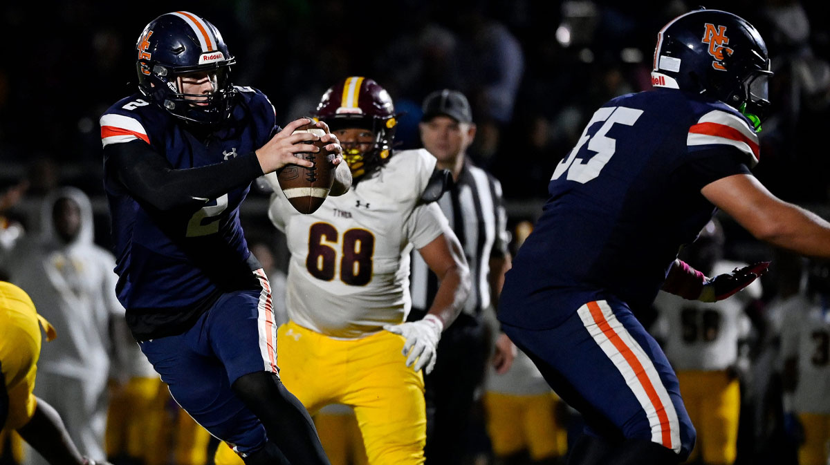 Nashville Christian quarterback Jared Curtis (2) scrambles away from Tyner’s Jaqruan Little (68) during a high school football game.