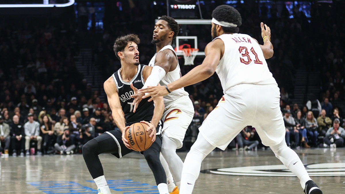 Brooklyn Nets guard Ben Saraf (77) is double teammed by Cleveland Cavaliers guard Donovan Mitchell (45) and center Jarrett Allen (31) in the first quarter at Barclays Center.