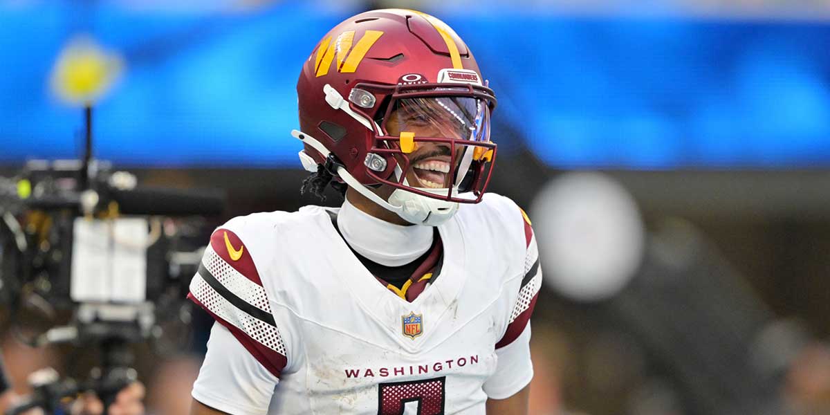 Washington Commanders quarterback Jayden Daniels (5) celebrates after a touchdown against the Los Angeles Chargers in the second half at SoFi Stadium. 
