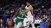 Boston Celtics guard Jaylen Brown (7) dribbles defended by Detroit Pistons forward Tobias Harris (12) in the first half at Little Caesars Arena.