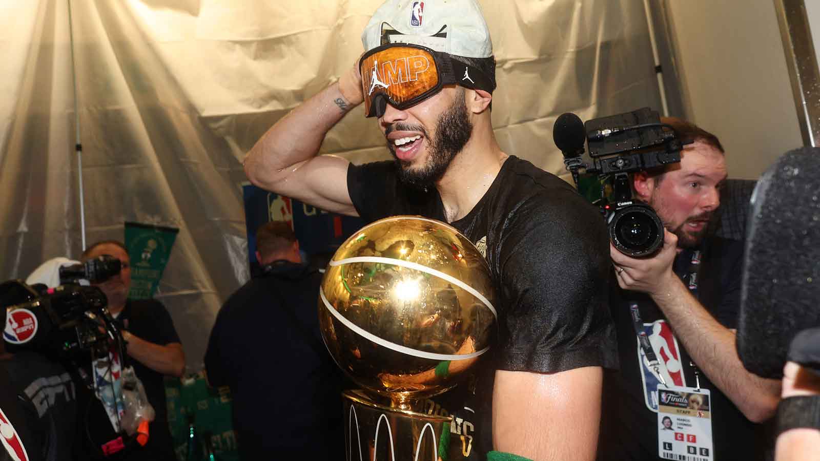 Boston Celtics forward Jayson Tatum (0) celebrates in the locker room after winning the 2024 NBA Finals against the Dallas Mavericks at TD Garden.