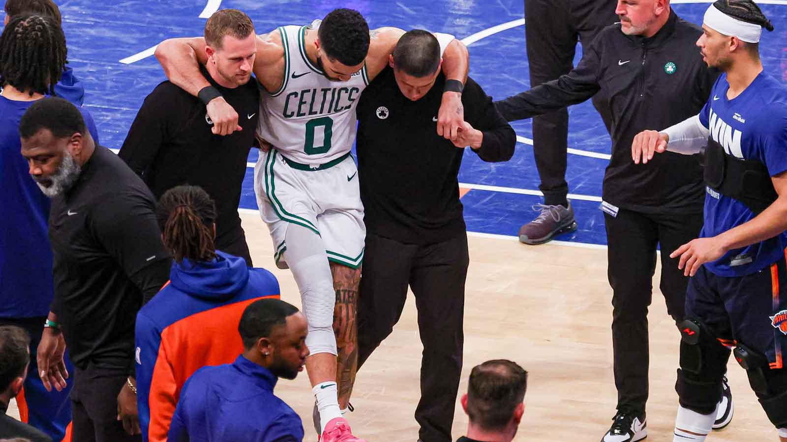 Boston Celtics forward Jayson Tatum (0) is helped off the court by after an injury in the second half during game four of the second round for the 2025 NBA Playoffs against the New York Knicks at Madison Square Garden. Tatum would leave the game with an injury after this play.