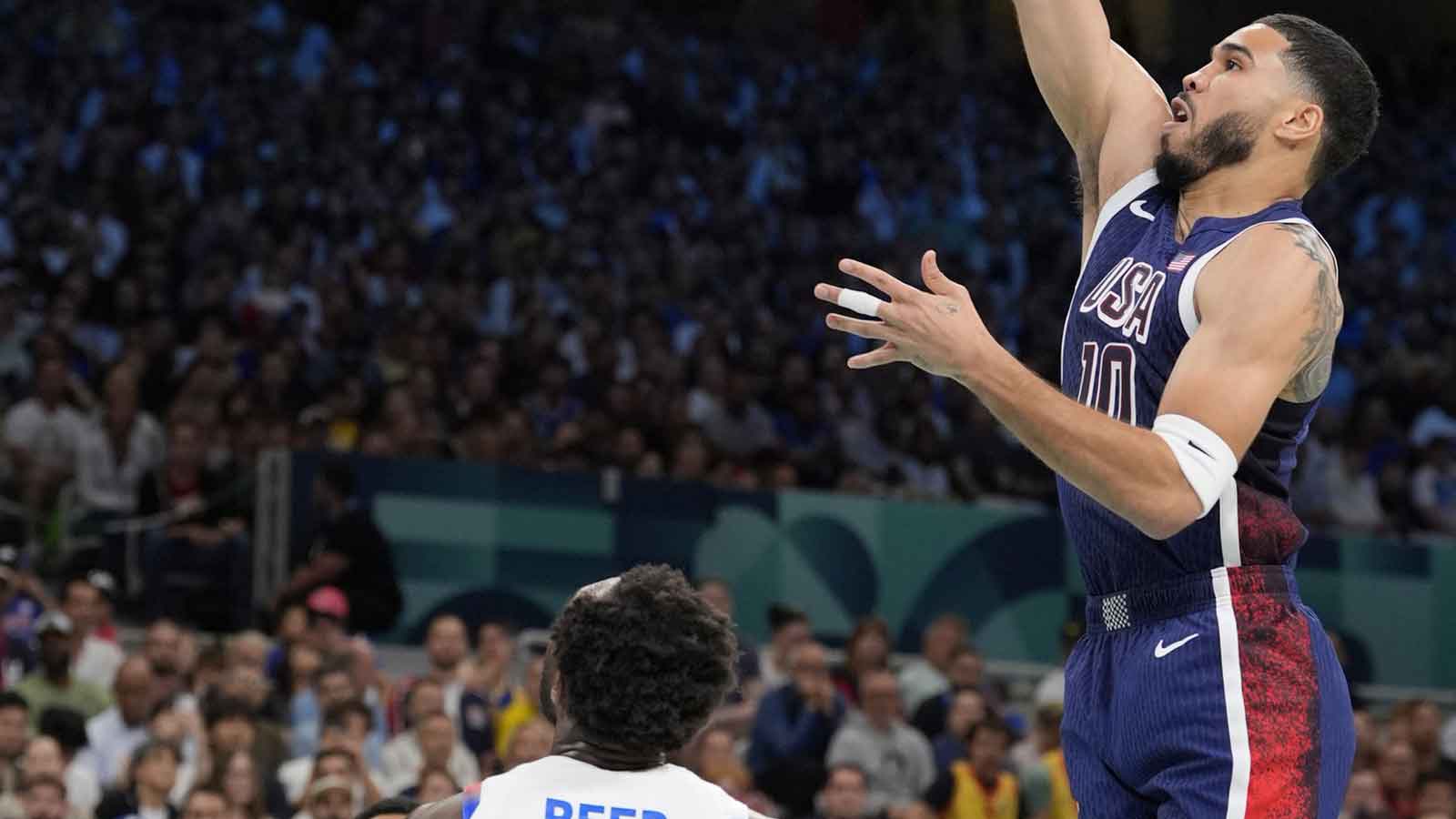 United States small forward Jayson Tatum (10) shoots against Puerto Rico shooting guard Davon Reed (9) during the first quarter during the Paris 2024 Olympic Summer Games at Stade Pierre-Mauroy.
