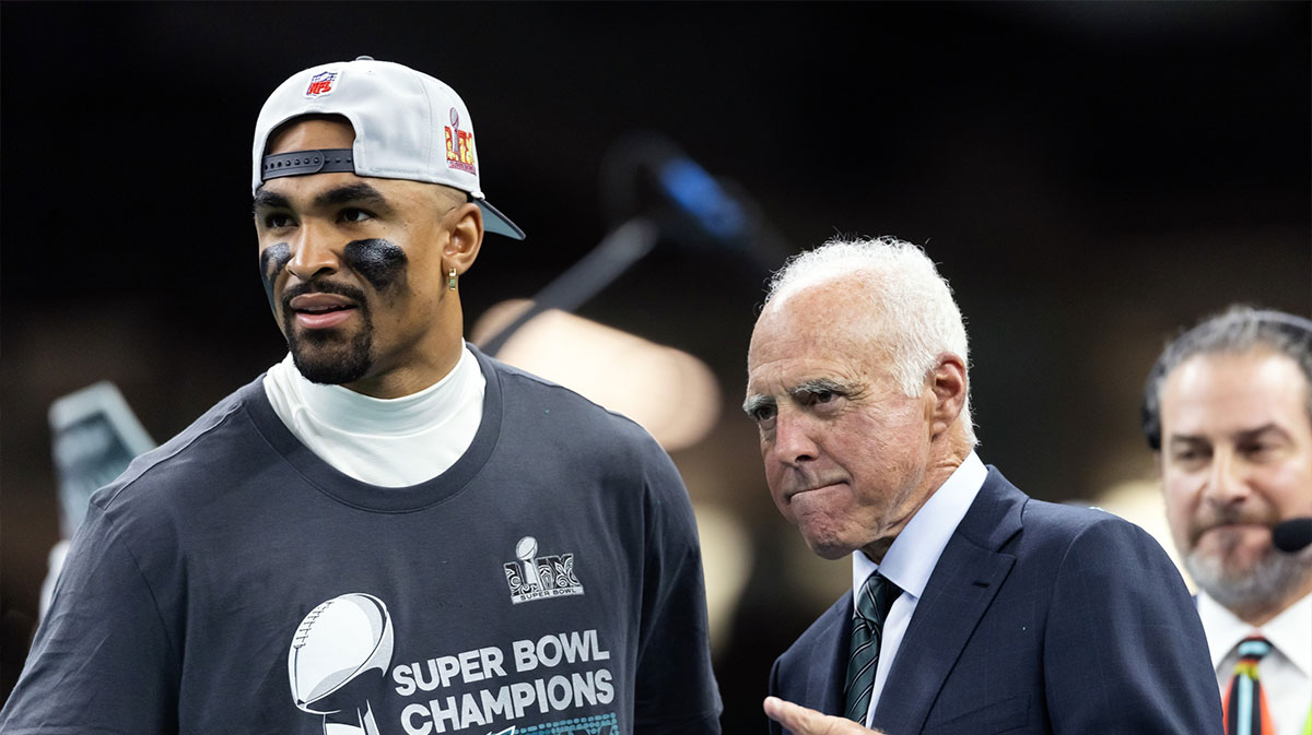 Philadelphia Eagles quarterback Jalen Hurts (left) celebrates with owner Jeffrey Lurie after defeating the Kansas City Chiefs to win Super Bowl LIX at Ceasars Superdome.