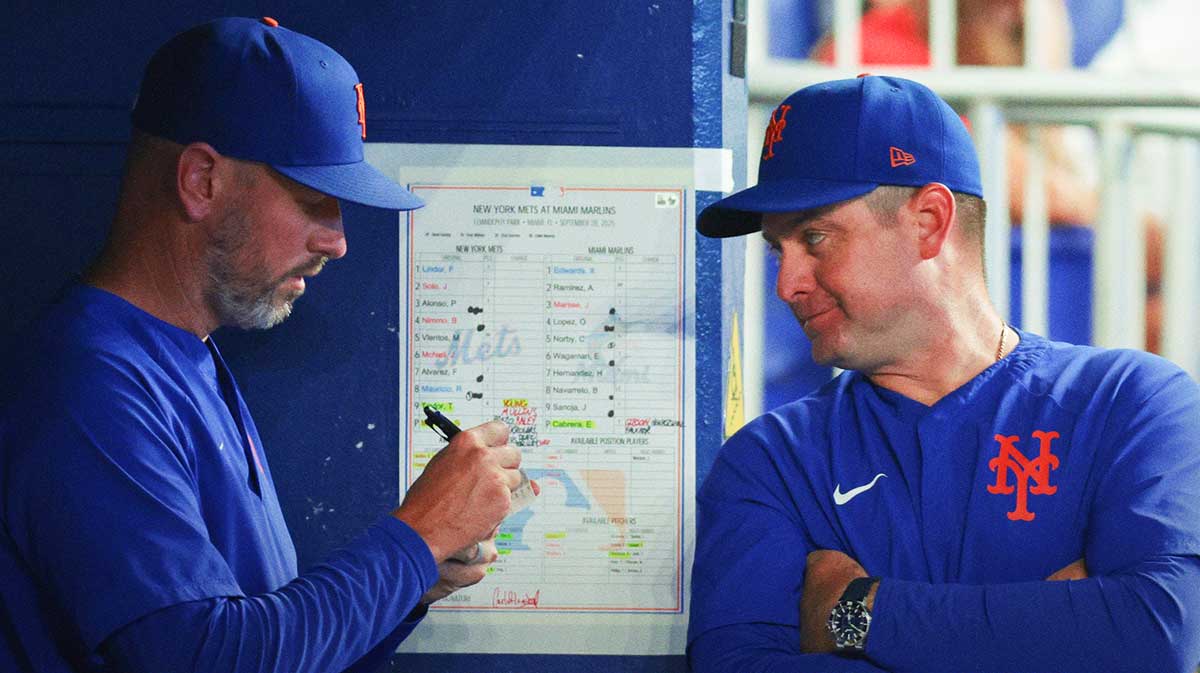 New York Mets manager Carlos Mendoza (64) talks to pitching coach Jeremy Hefner (95) against the Miami Marlins during the eighth inning at loanDepot Park.