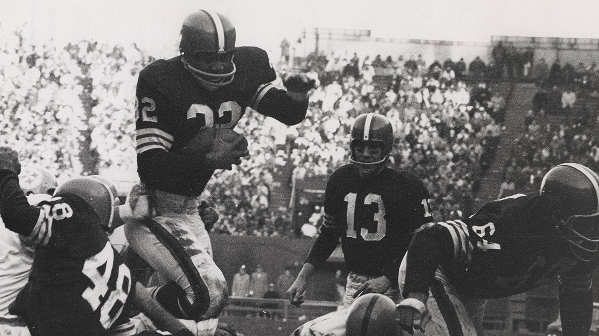 FILE PHOTO; Cleveland Browns running back Jim Brown (32) leaps for a touchdown over Pittsburgh Steelers defensive tackle Big Daddy Lipscomb (76),