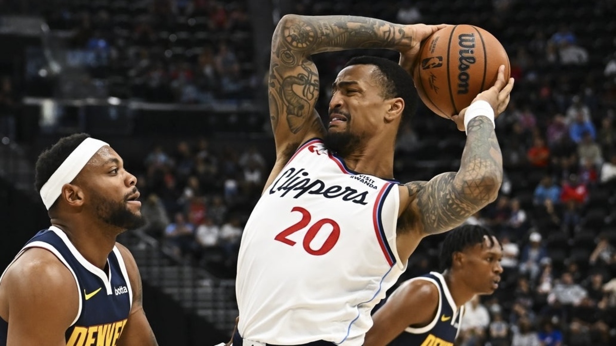 Los Angeles Clippers forward John Collins (20) looks to pass against Denver Nuggets guard Bruce Brown (11) during the second quarter at Intuit Dome.