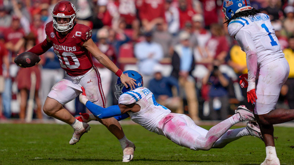 Oklahoma Sooners quarterback John Mateer (10) runs beside Ole Miss Rebels linebacker Suntarine Perkins (4) during a college football game between the University of Oklahoma Sooners (OU) and the Ole Miss Rebels at Gaylord Family Ð Oklahoma Memorial Stadium in Norman, Okla., Saturday, Oct. 25, 2025. Ole Miss won 34-26.