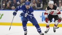 ronto, Ontario, CAN; Toronto Maple Leafs forward John Tavares (91) and New Jersey Devils defenseman Brett Pesce (22) chase a loose puck during the first period at Scotiabank Arena.