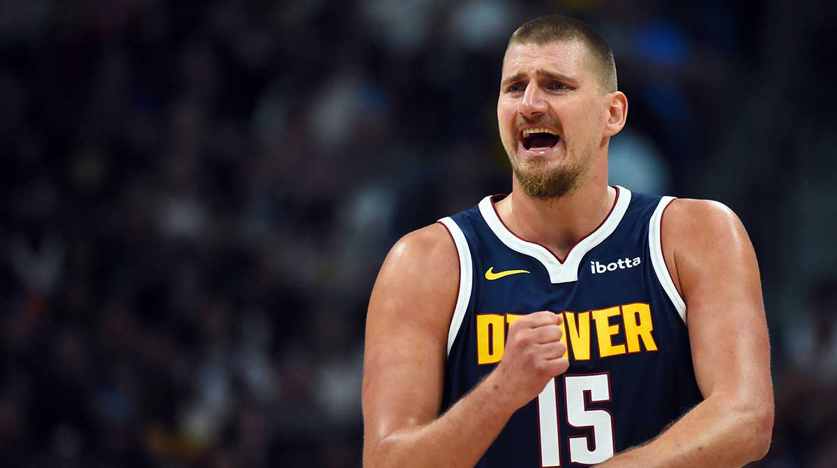 Denver Nuggets center Nikola Jokic (15) talks with the bench during the first half against the Phoenix Suns at Ball Arena