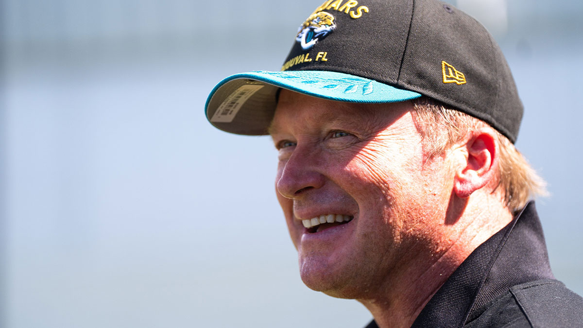Former NFL Coach Jon Gruden have a laugh while attending an NFL training camp session ten at the Miller Electric Center, Tuesday, Aug. 5, 2025, in Jacksonville, Fla.