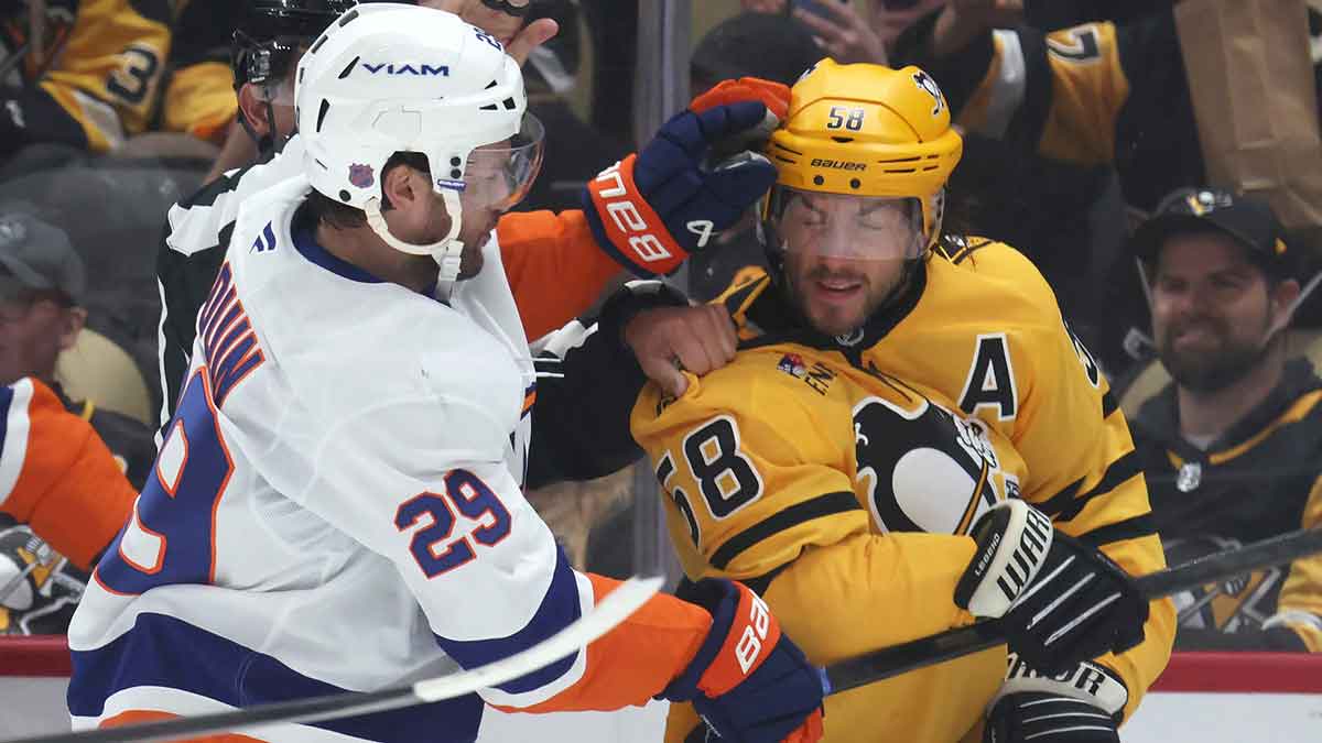 New York Islanders left wing Jonathan Drouin (29) and Pittsburgh Penguins defenseman Kris Letang (58) fight during the second period at PPG Paints Arena