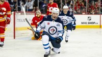 Winnipeg Jets center Jonathan Toews (19) celebrates after scoring a goal on Calgary Flames goaltender Dustin Wolf (32) during the third period at Scotiabank Saddledome.