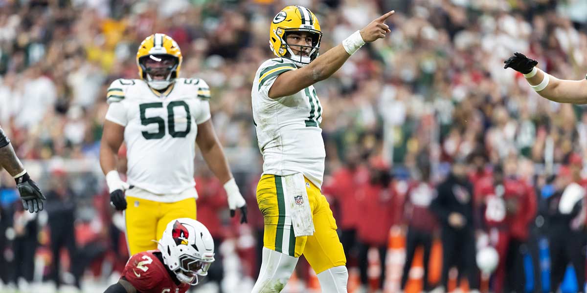 Green Bay Packers quarterback Jordan Love (10) celebrates a first down against the Arizona Cardinals in the second half at State Farm Stadium