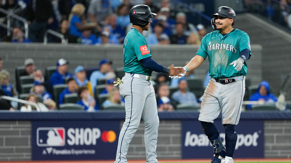Seattle Mariners infielder Josh Naylor (12) celebrates a two run home run with infielder Jorge Polanco (7) in the seventh inning against the Toronto Blue Jays during game two of the ALCS round for the 2025 MLB playoffs at Rogers Centre.