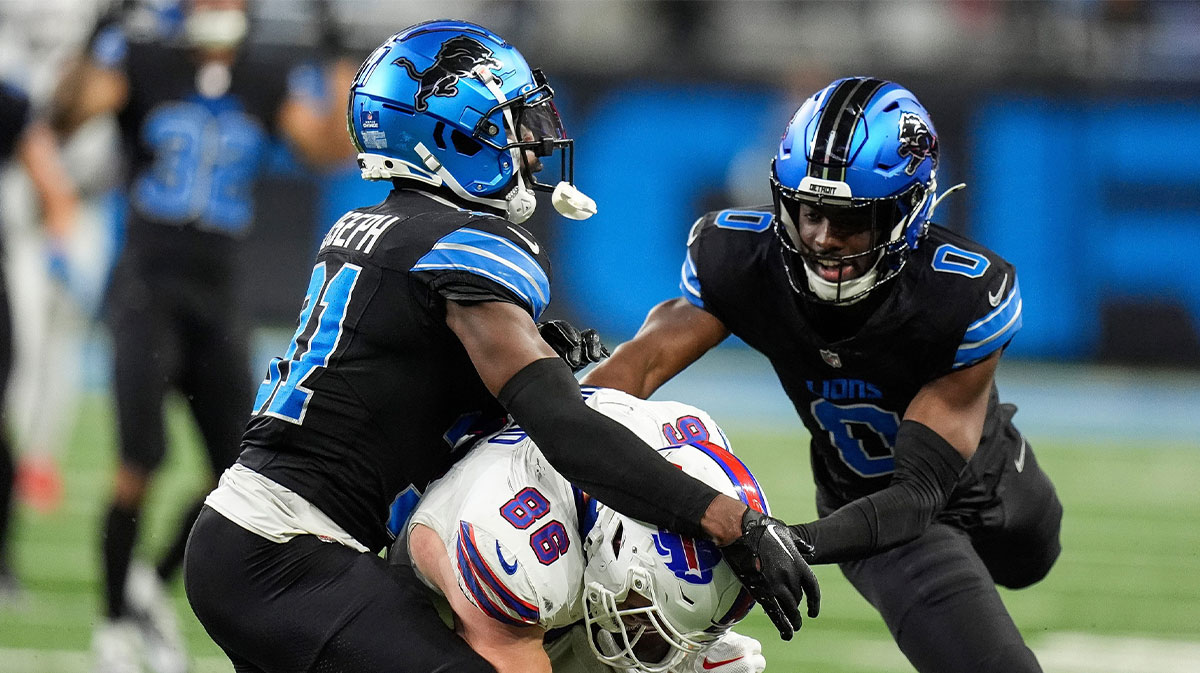 Detroit Lions safety Kerby Joseph (31), left, cornerback Terrion Arnold (0), tackle Buffalo Bills tight end Dalton Kincaid (86) during the second half at Ford Field in Detroit on Sunday, Dec. 15, 2024.