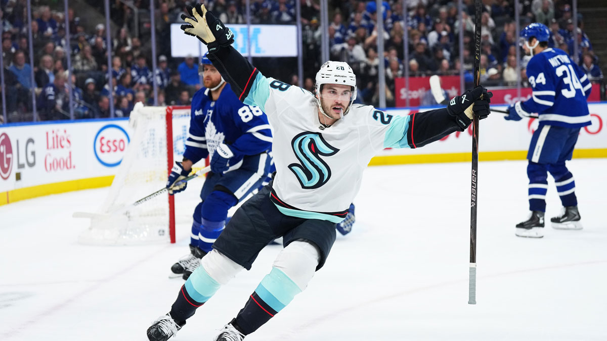 Seattle Kraken defenseman Joshua Mahura (28) celebrates after scoring the winning goal against the Toronto Maple Leafs during the overtime period at Scotiabank Arena.
