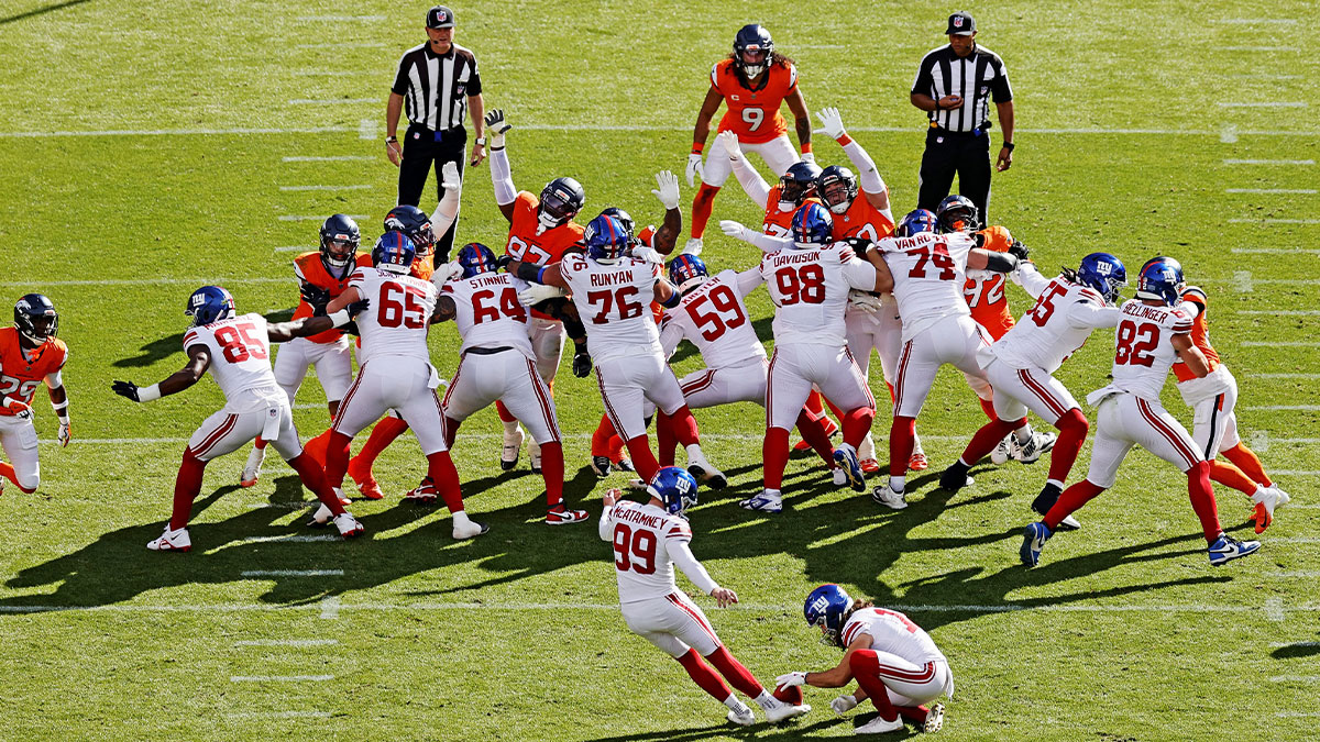 New York Giants kicker Jude McAtamney (99) kicks a field goal during the second half against the Denver Broncos at Empower Field at Mile High.