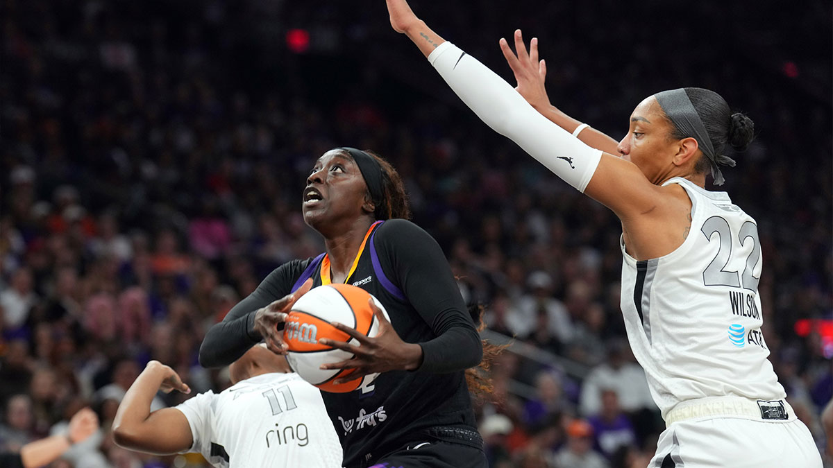 Phoenix Mercury guard Kahleah Copper (2) drives against Las Vegas Aces guard Dana Evans (11) and Las Vegas Aces center A'ja Wilson (22) during the second half of game four of the 2025 WNBA Finals at Mortgage Matchup Center.