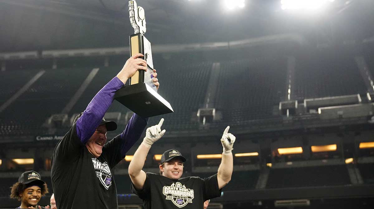 Kansas State head coach Chris Klieman lifts the Rate Bowl trophy after beating Rutgers in the Rate Bowl at Chase Field on Dec. 26, 2024, in Phoenix.