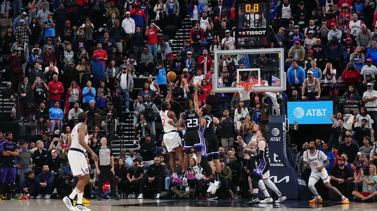 LA Clippers forward Kawhi Leonard (2) shoots the game-winning shot against Sacramento Kings guard Keon Ellis (23) and center Jonas Valanciunas (17) in overtime at the Intuit Dome.