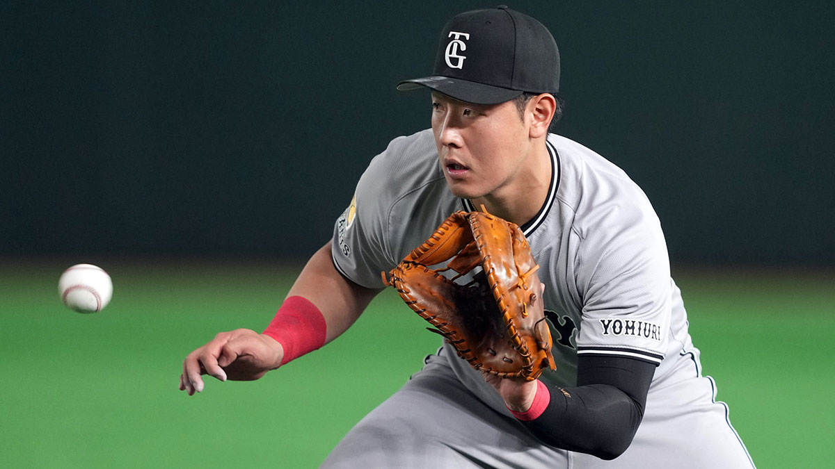 Yomiuri Giants first baseman Kazuma Okamoto (25) fields a ground ball against the Los Angeles Dodgers during the fifth inning at Tokyo Dome.
