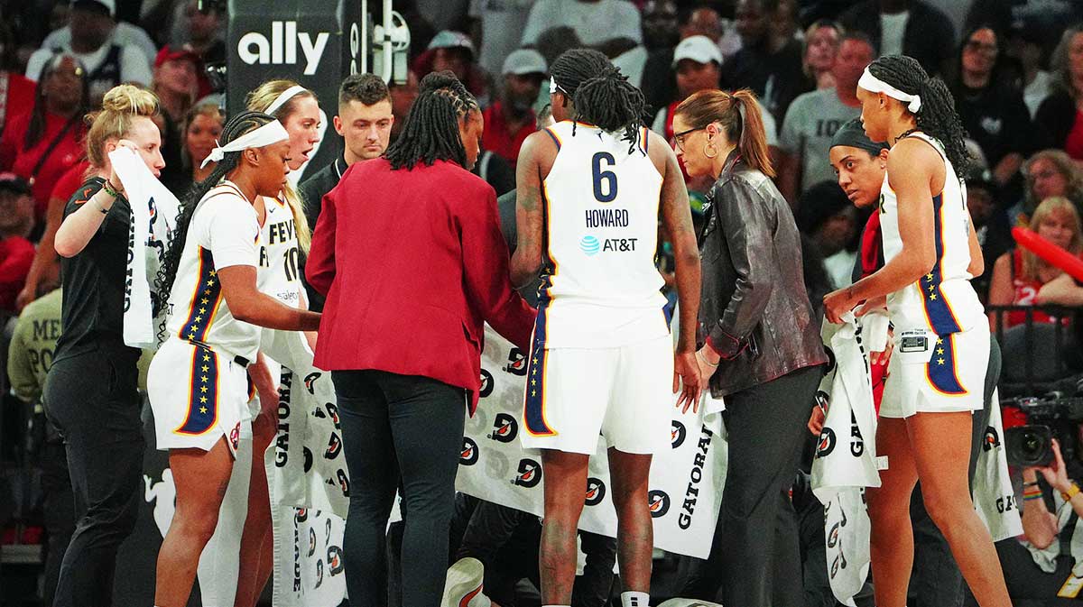 Indiana Fever players and coaching staff gather around Indiana Fever guard Kelsey Mitchell (0) who suffered an injury playing against the Las Vegas Aces in the third quarter of game five of the second round for the 2025 WNBA Playoffs at Michelob Ultra Arena.