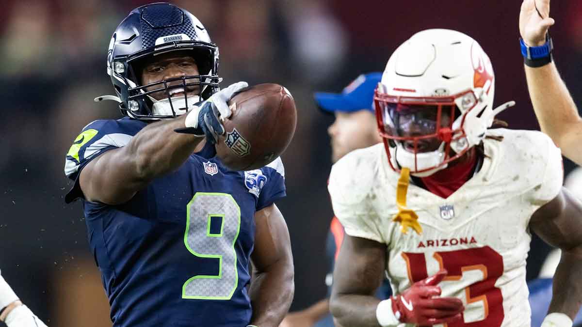 Seattle Seahawks running back Kenneth Walker III (9) taunts an Arizona Cardinals defender at State Farm Stadium.