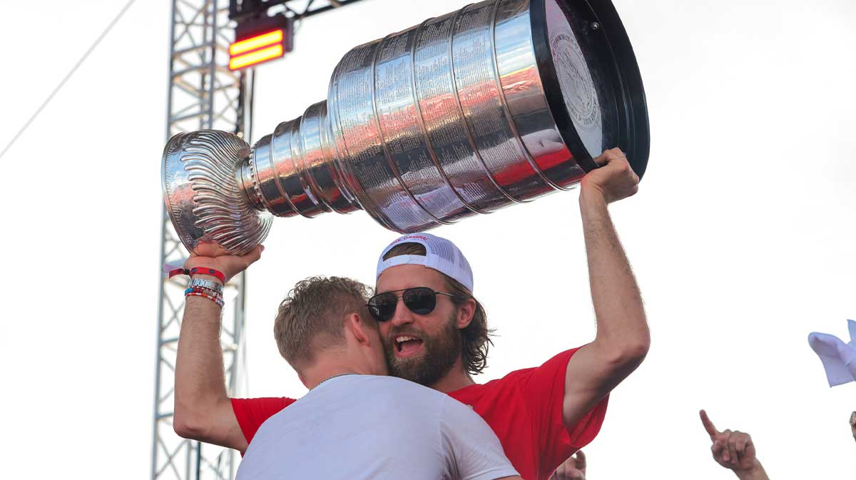 Florida Panthers defenseman Aaron Ekblad (5) hoist the Stanley Cup as center Anton Lundell (15) gives him a hug during the Stanley Cup championship parade and rally.