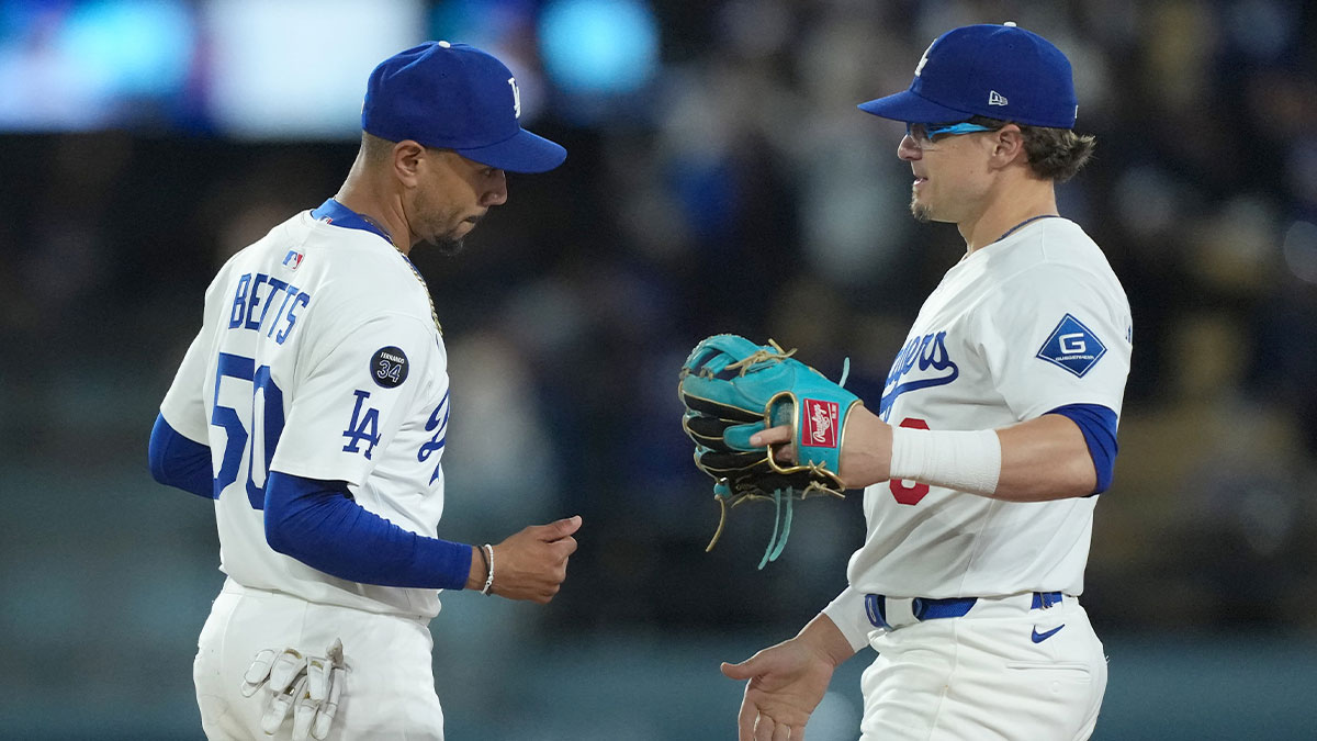 Los Angeles Dodgers shortstop Mookie Betts (50) and second baseman Kike Hernandez (8) celebrate after a game against the Colorado Rockies at Dodger Stadium.