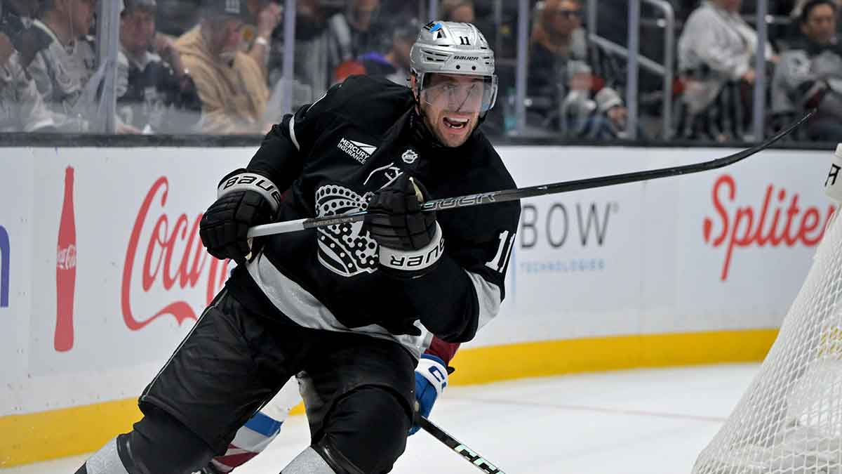 Los Angeles Kings center Anze Kopitar (11) and Colorado Avalanche center Ross Colton (20) chase down the puck during the third period at Crypto.com Arena.