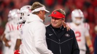 Mississippi Rebels head coach Lane Kiffin talks to Georgia Bulldogs head coach Kirby Smart before a game at Sanford Stadium.