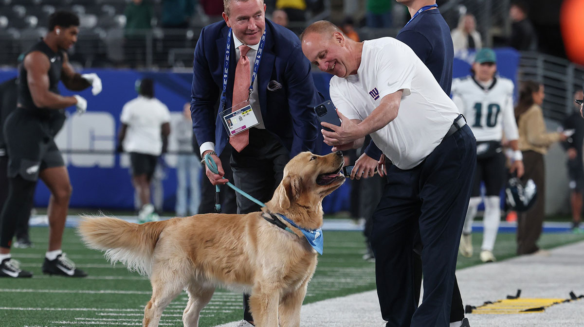 Amazon Prime Thursday Night Football sportscaster Kirk Herbstreit, left, and his dog Peter take a photo before the game between the New York Giants and the Philadelphia Eagles at MetLife Stadium.