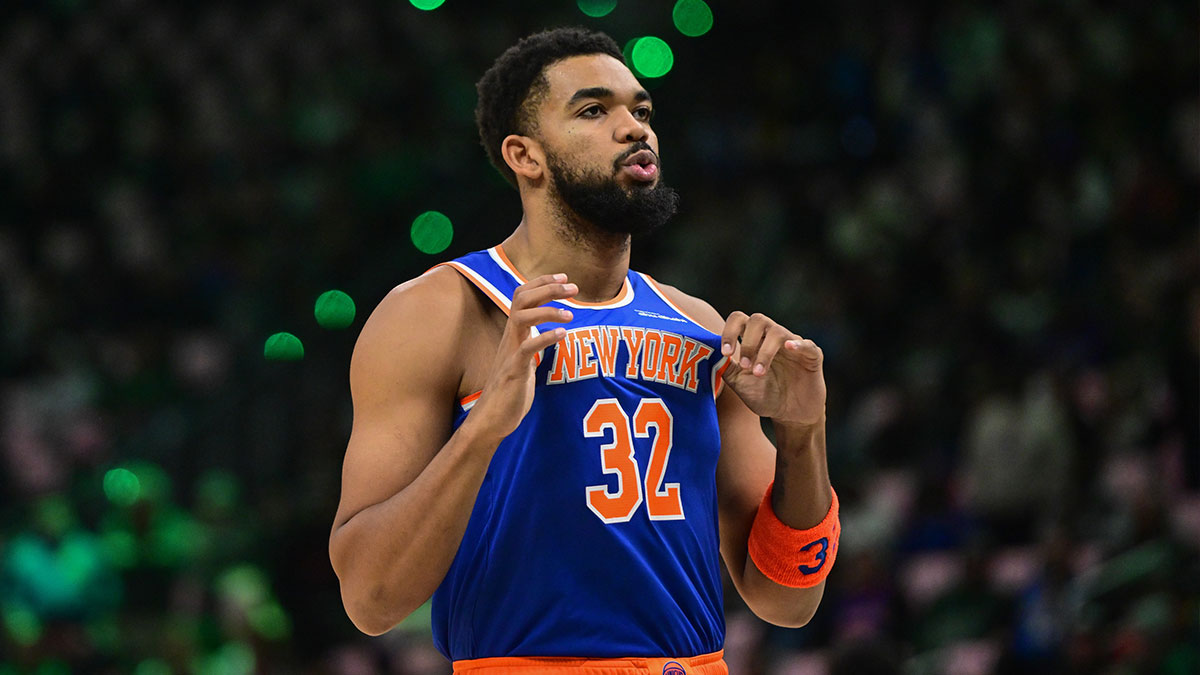 Knicks center Karl-Anthony Towns (32) gestures before game against the Milwaukee Bucks at Fiserv Forum with ESPN's Kendrick Perkins in the background