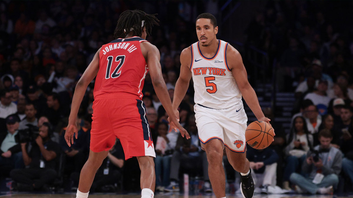 Oct 13, 2025; New York, New York, USA; New York Knicks guard Malcolm Brogdon (5) dribbles against Washington Wizards guard Tre Johnson (12)during the first half at Madison Square Garden. Mandatory Credit: Vincent Carchietta-Imagn Images
