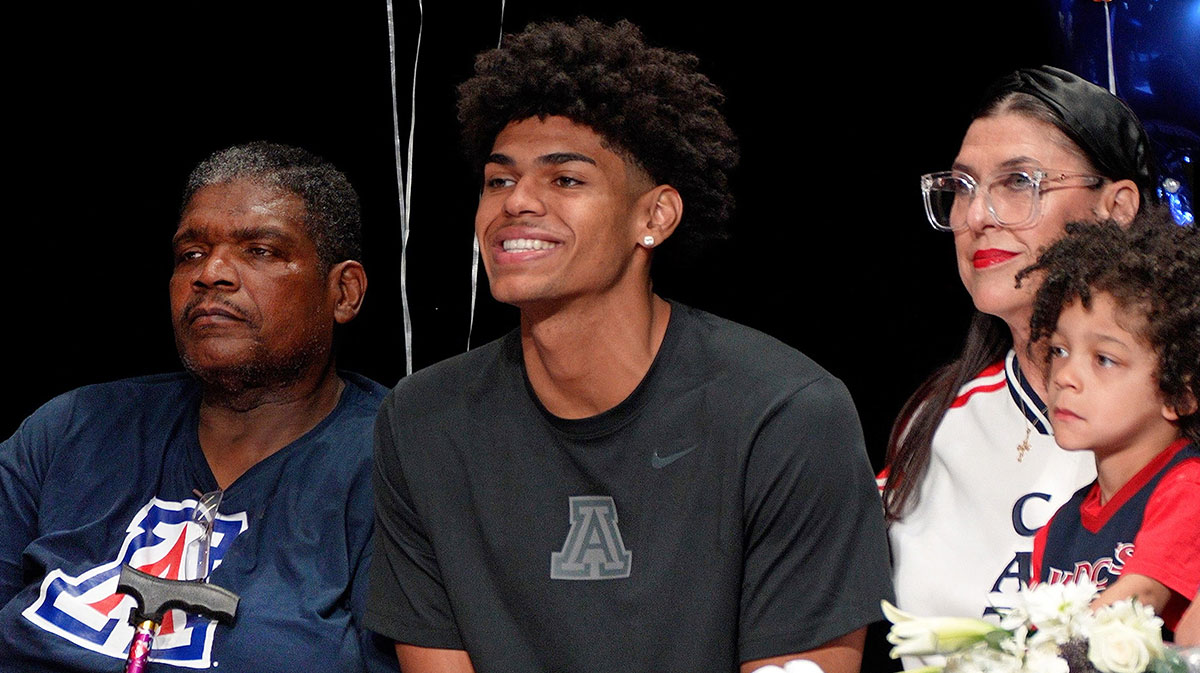 Basketball player Koa Peat sits with his father, Todd, left, mother, Jana, and nephew, Samson, during National Signing Day at Perry High School in Gilbert, Arizona on April 16, 2025.