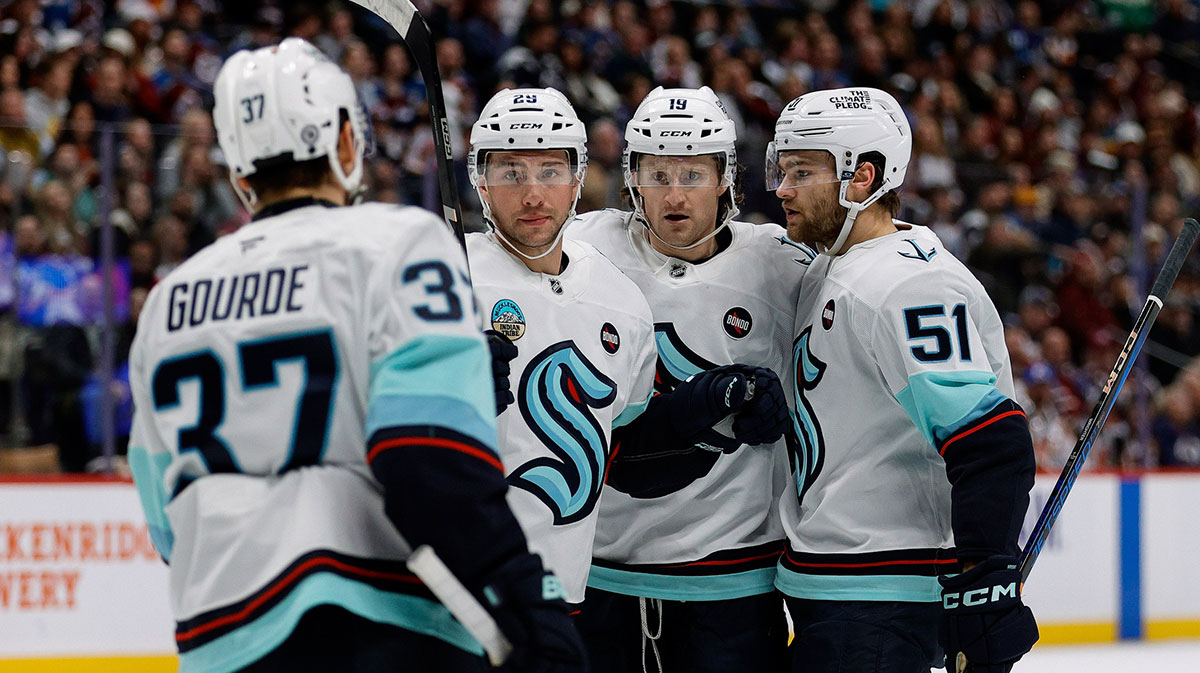 Seattle Kraken left wing Jared McCann (19) celebrates his goal with defenseman Vince Dunn (29) and center Shane Wright (51) and center Yanni Gourde (37).