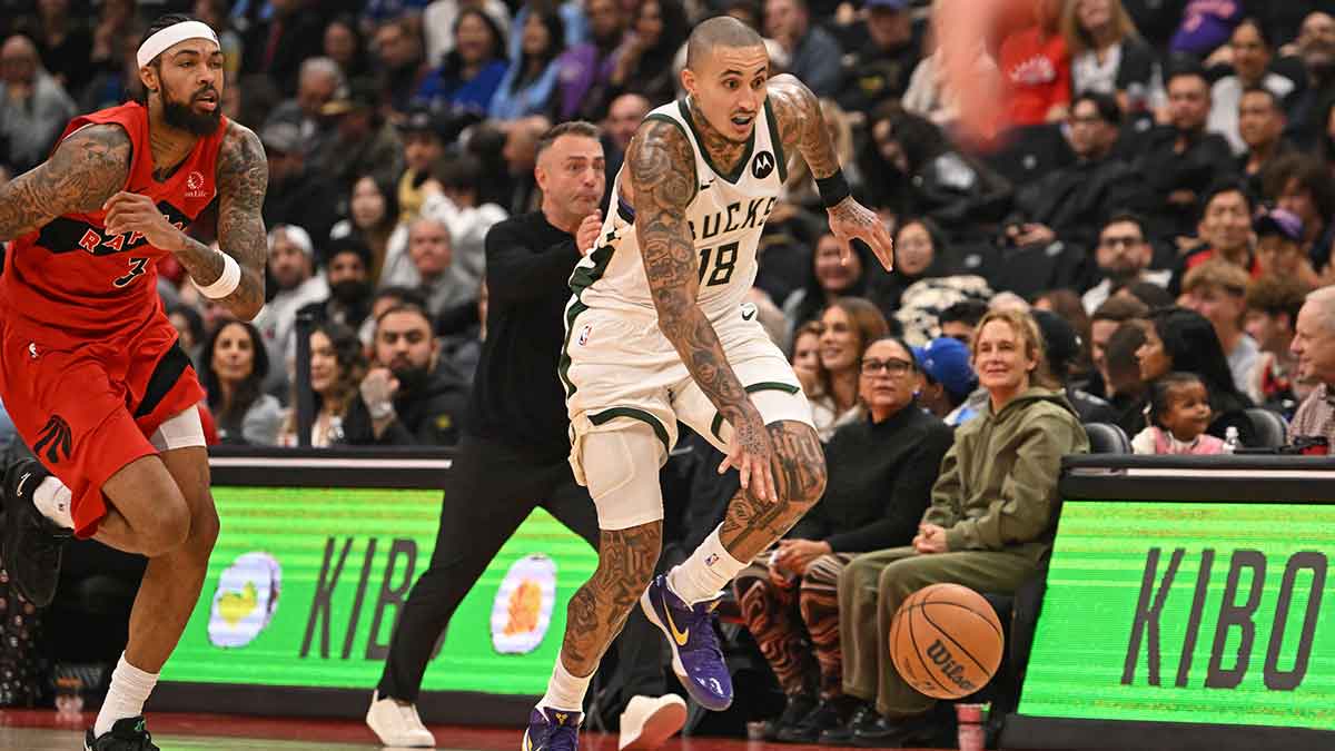 Milwaukee Bucks forward Kyle Kuzma (18) dribbles past Toronto Raptors forward Brandon Ingram (3) in the second quarter at Scotiabank Arena.