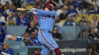 Philadelphia Phillies designated hitter Kyle Schwarber (12) hits a solo home run during the fourth inning against the Los Angeles Dodgers in game three of the NLDS during the 2025 MLB playoffs at Dodger Stadium.
